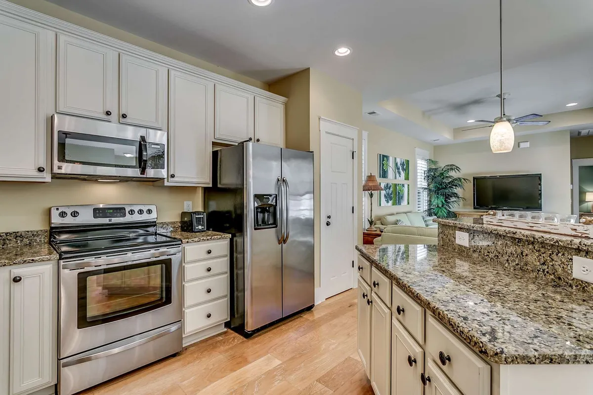 A close-up of the kitchen's granite countertop, sleek cabinetry, and stainless steel appliances. The scene is set up for both everyday cooking and festive gatherings, with plenty of workspace and a warm, inviting atmosphere.